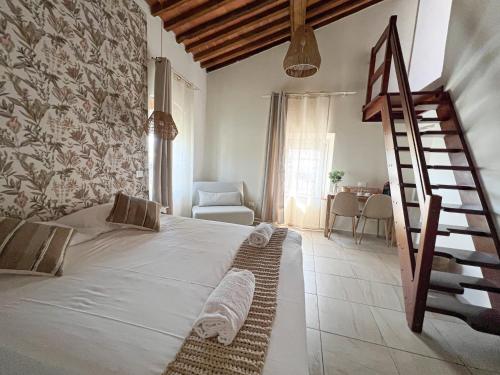 ein Schlafzimmer mit einem großen Bett und einer Treppe in der Unterkunft NEW! -Verderame Rooms & Suite in Lucca in Lucca