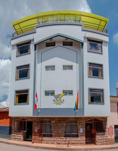a large white building with a yellow dome on top at Hotel Wayra Dreams in Cusco