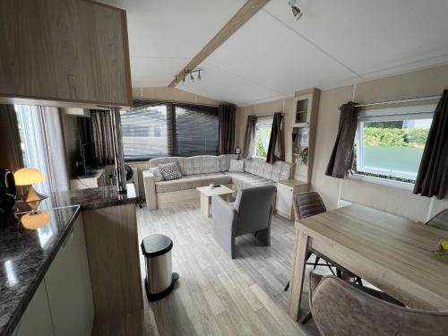 a living room with a couch and a table at ZP 508 - Camping de Zandput in Vrouwenpolder