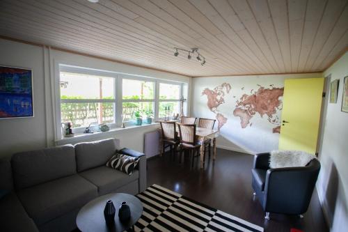 a living room with a couch and a world map on the wall at Lovely 2- bedroom apartment in central Tórshavn in Tórshavn