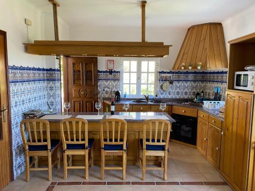 a kitchen with a large wooden table and chairs at Villa Samaritana - Casa da Vinha in Vila Marim