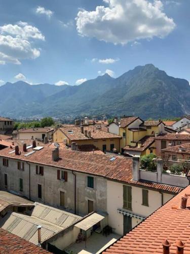 a city with buildings and mountains in the background at Casa Cavour Lecco - Downtown Design Penthouse in Lecco