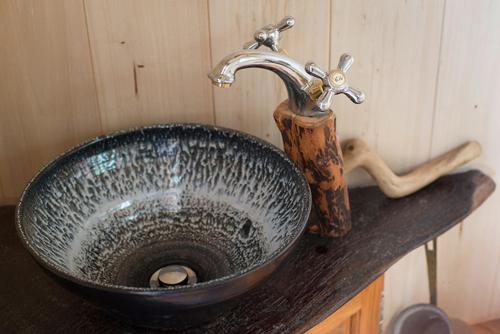 a bathroom sink with a faucet on a counter at Yourte La Désirade in Semur-en-Auxois