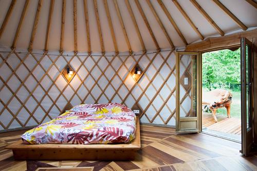 a room with a bed in a yurt at Yourte La Désirade in Semur-en-Auxois