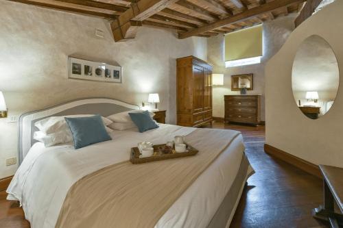 a bedroom with a large white bed in a room at Tiepolo romantic penthouse in the Oltrarno in Florence