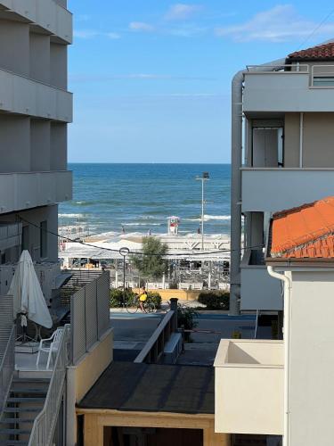 a view of the beach from the balcony of a building at Appartamento Via Rieti in Senigallia