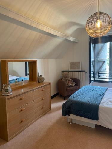 a bedroom with a bed and a sink and a mirror at Cottage Philmaries in Coudert