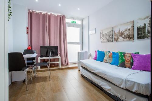 sypialnia z łóżkiem i biurkiem z komputerem w obiekcie ApartEasy - Goya Ground Floor Studio w Madrycie