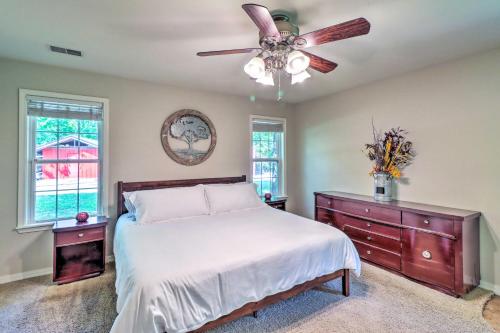 a bedroom with a bed and a ceiling fan at Higden Home with Furnished Porch, Spacious Yard in Fairfield Bay