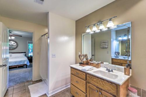 a bathroom with a sink and a mirror at Higden Home with Furnished Porch, Spacious Yard in Fairfield Bay