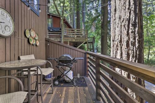 a deck with a table and a stroller and a clock at Tranquil Guerneville Home with Redwood Views in Guerneville
