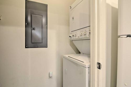 a white laundry room with a washer and dryer at Porch and Community Perks Walkable Lewes Condo in Lewes