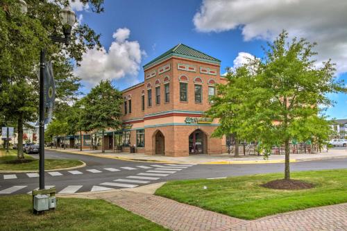a large brick building on a street with a tree at Porch and Community Perks Walkable Lewes Condo in Lewes
