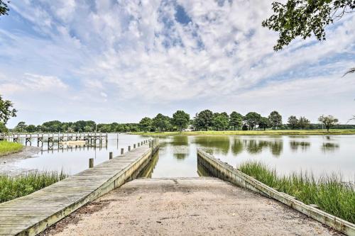 a dock on a lake with a cloudy sky at Pet-Friendly Woodsy Gem quarter Mi to Chesapeake Bay in Exmore