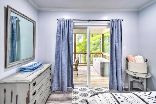 a bedroom with a bed and a door to a deck at Relaxing Riverfront Cottage with Boat Dock! in Locklies