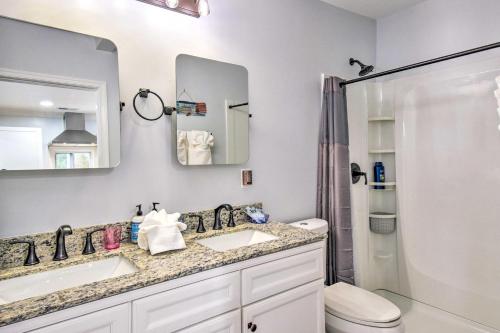a bathroom with two sinks and a toilet at Relaxing Riverfront Cottage with Boat Dock! in Locklies
