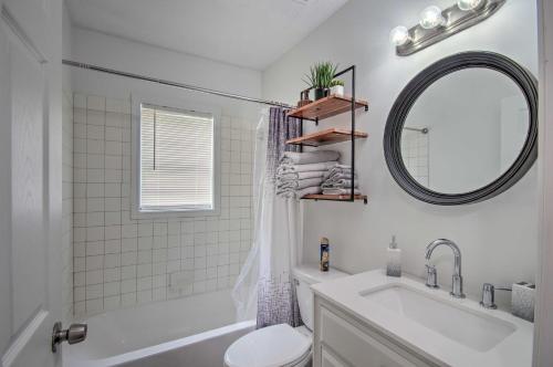 a white bathroom with a sink and a mirror at Updated Jackson Home about 3 Mi to JSU Stadium! in Jackson
