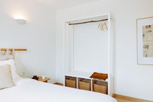 a bedroom with a white bed and a window at Oliveiras Village — Agroturismo in Amarante