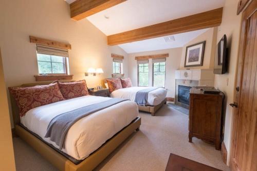 a large bedroom with two beds and a fireplace at Hotel 2 Queen Hotel Room in Park City