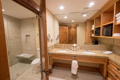 a bathroom with two sinks and a shower at Hotel 2 Queen Hotel Room in Park City