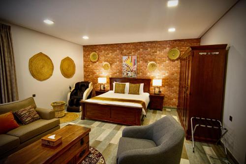 a bedroom with a bed and a living room with a couch at Coastline Resort in Mussanah