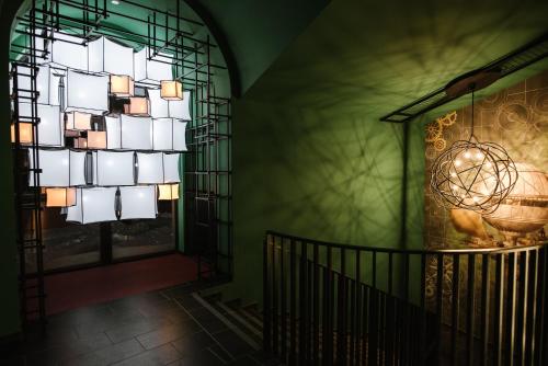 a staircase with a large window and a chandelier at Hotel Zefir in Drohobytsch