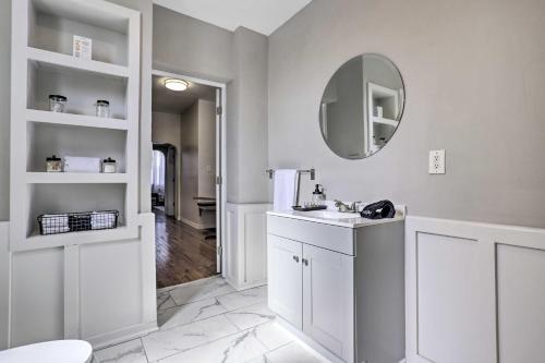 a white bathroom with a sink and a mirror at Updated Bayonne Townhome about 11 Mi to NYC! in Bayonne