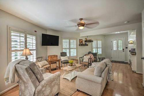 a living room with chairs and a ceiling fan at 1 Mi to Jenkinson Lake Apples Chalet with Deck in Pollock Pines