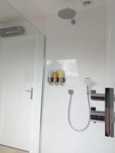 a bathroom with a glass door and a shower at Villa 't Zonneroosje in Nieuwpoort