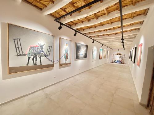 an art gallery with paintings on the walls at taman'art space in Aït Ben Haddou