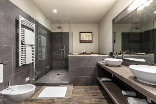 a bathroom with two sinks and a shower at Studio Inn De Angeli in Milan