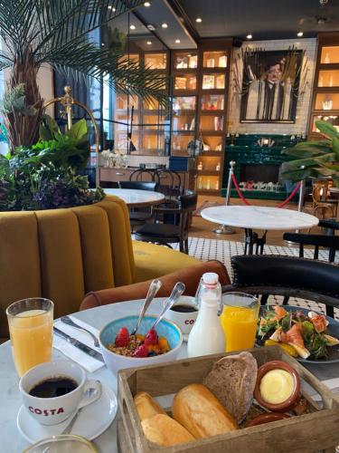 a breakfast table with a tray of food and drinks at Craves in Brussels