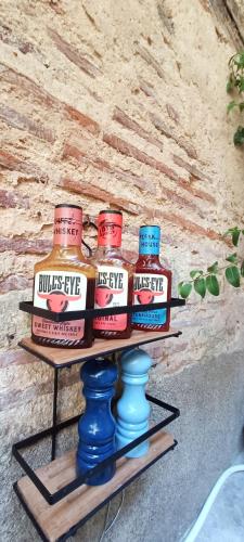a shelf with three jars of sauce on it at Studio atypique Immeuble de 1820 in Fumel