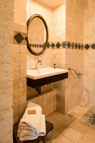 a bathroom with a sink and a mirror at Hôtel Mas Vidau Porte des Alpilles in Saint-Étienne-du-Grès
