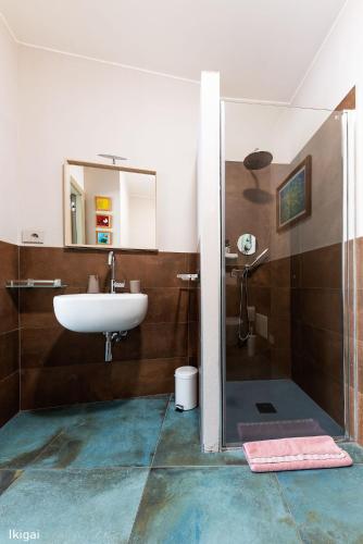 a bathroom with a sink and a shower at San Francesco Guest House in Savigliano