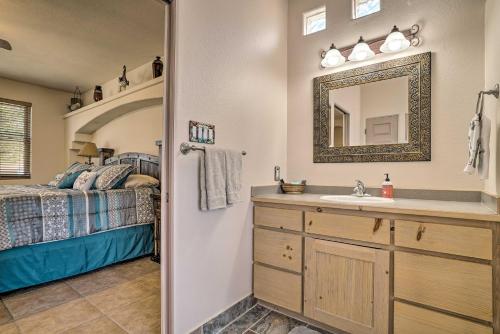a bathroom with a sink and a bed and a mirror at Rustic Las Cruces Escape - 2 Mi to NMSU! in Las Cruces