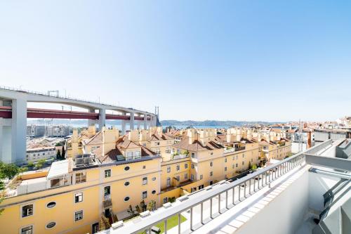 a view of the city from the balcony of a building at Lusíadas 53 5ºE - Beautiful River View in Lisbon