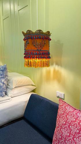 a bedroom with a bed with a colorful head board at Baan Bua Cottage SHA EXTRA PLUS B5510 in Ko Kood
