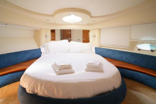 a bedroom with a large bed in a boat at Sailing 360 Night On Board Experience in Vila Nova de Gaia