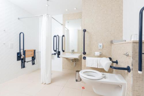 a bathroom with a toilet and a sink at Holiday Inn Manchester-Mediacityuk, an IHG Hotel in Manchester