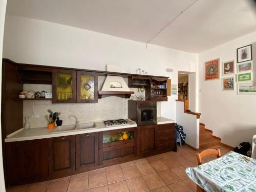 a kitchen with a sink and a stove top oven at La Casa al Mare in Monopoli