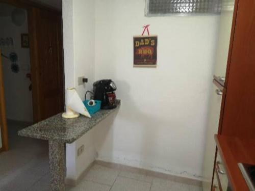 a counter in a kitchen with a sign on a wall at Casa Isa al mare in Santa Lucia