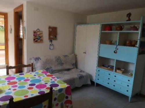 a room with a bed and a table and a cabinet at Casa Isa al mare in Santa Lucia