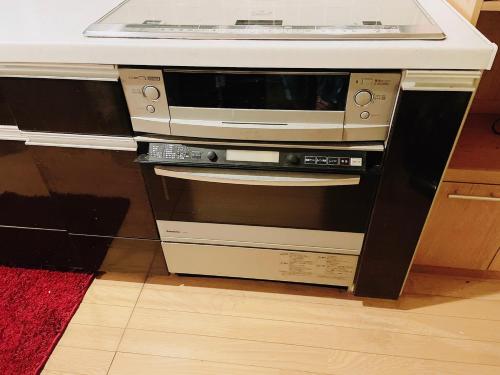 a microwave sitting on top of an oven at Sara in Kagoshima