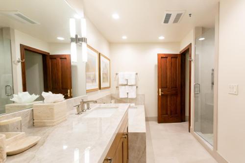 a bathroom with two sinks and a large mirror at Deluxe King Room with Fireplace Hotel Room in Park City