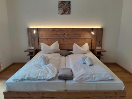a large white bed with two pillows on it at Ferien vom Ich, Bayerischer Wald, Hotel & Restaurant in Neukirchen