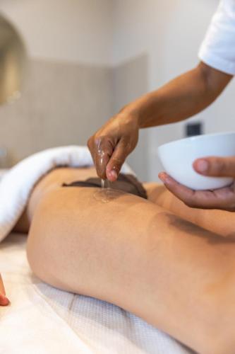a woman getting a massage from a masseur at MARINO WELLNESS in Ali Terme