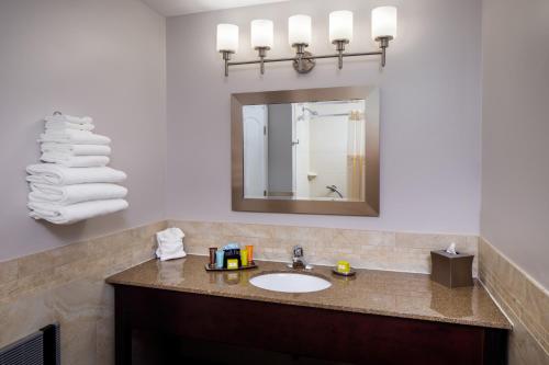 a bathroom with a sink and a mirror at Golden Gables Inn in North Conway