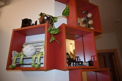 a red cabinet with a mirror and a plant at Villa Magicland in Sofia
