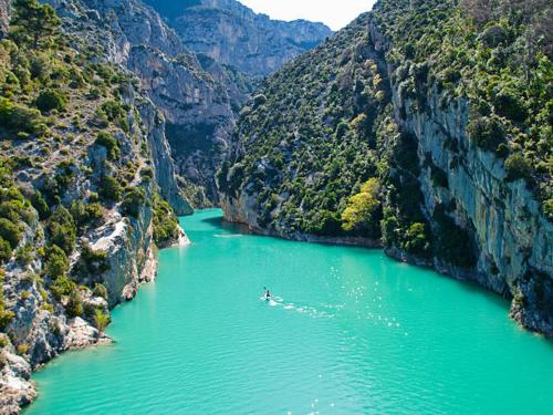 a boat in a river in a canyon at HUMAN HOTEL RESIDENCE ex esparrus in Villecroze